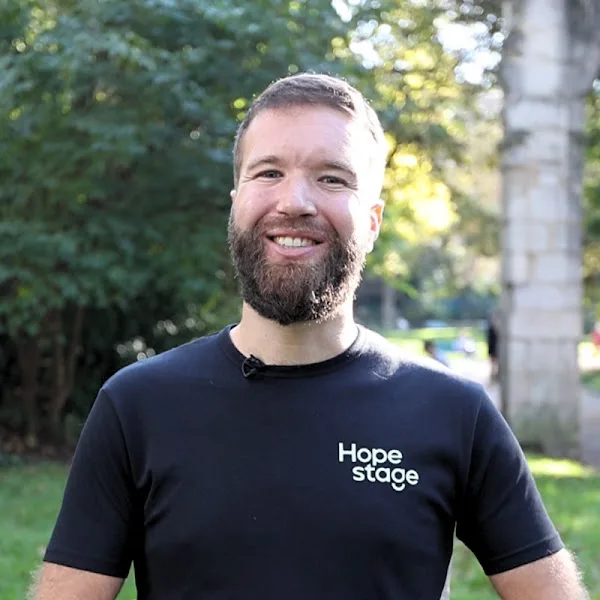 Clément Baissat smiling outdoors in a HopeStage T-shirt