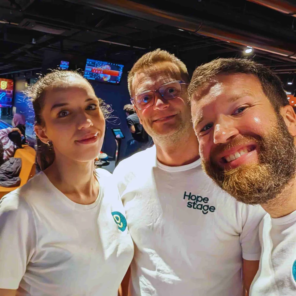 Clément, Manon and Julien smiling together, with HopeStage T-shirts